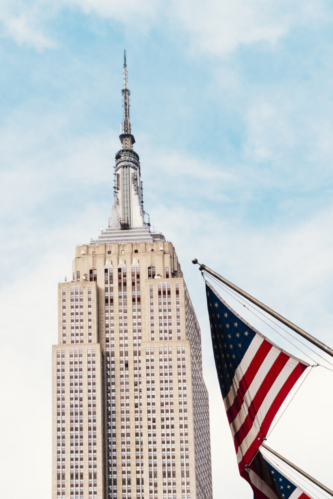 Usa Flag Waving Near Empire State Building 683x1024